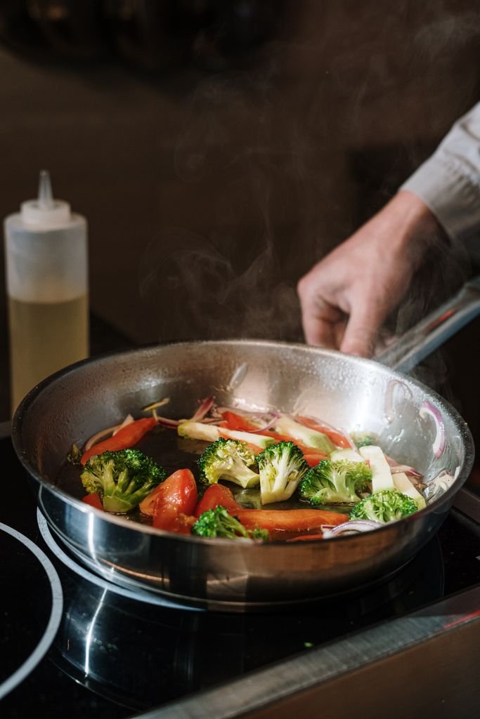 Best PFAS-free cookware brands 2026 - sauteing vegetables in a ceramic nonstick pan